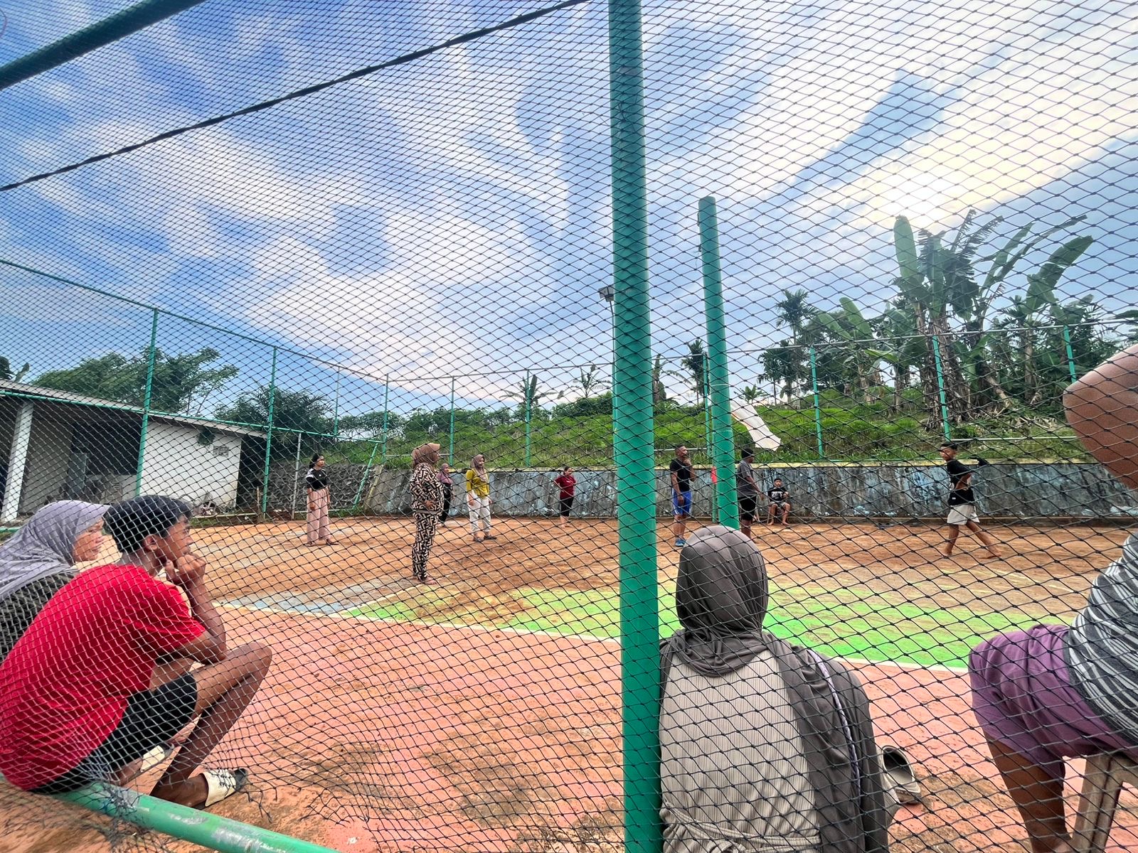 Bermain bola voli bersama warga desa air sebakul