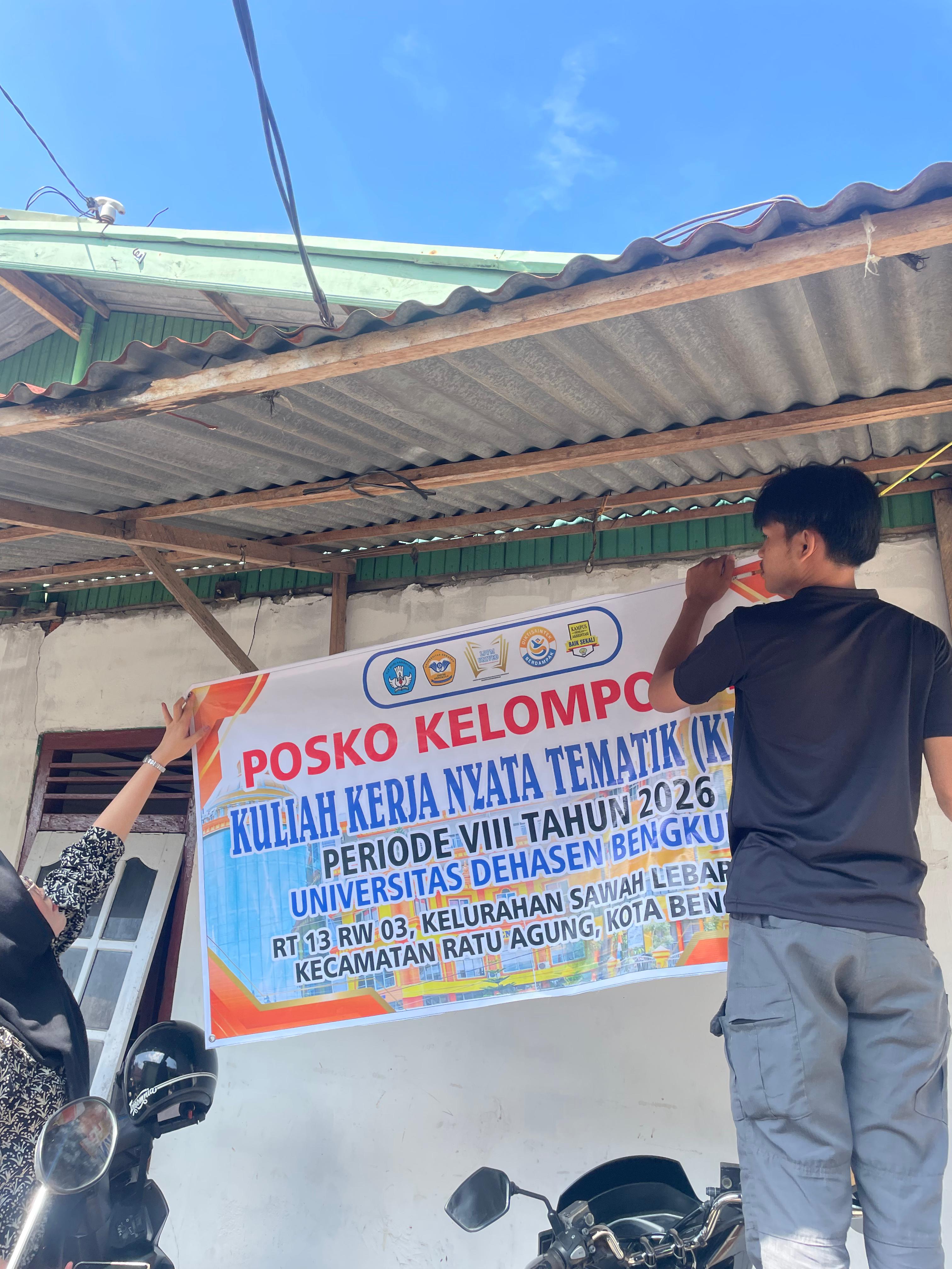 Pemasangan sepanduk posko KKN-T Kelompom 13